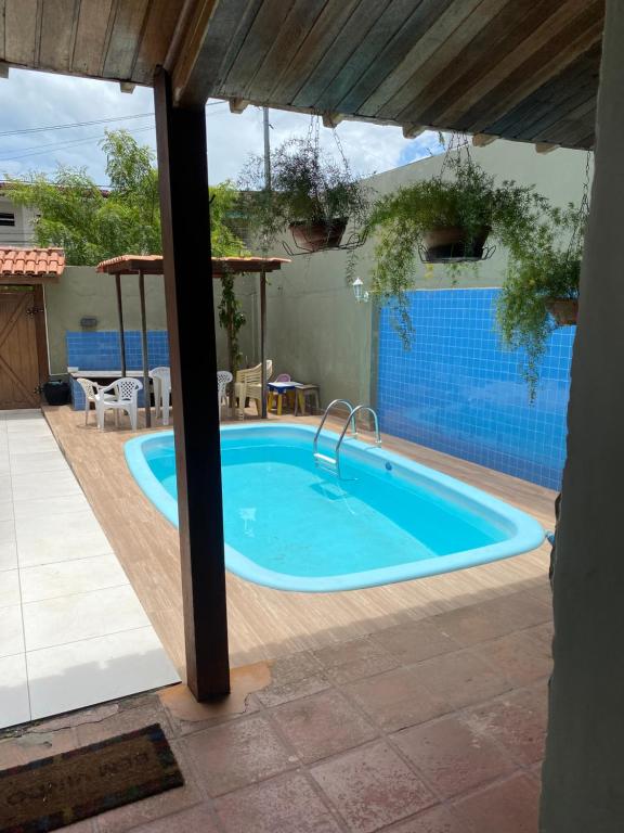 a swimming pool in a house with a large swimming pool at Casa grande e bela in Porto Seguro