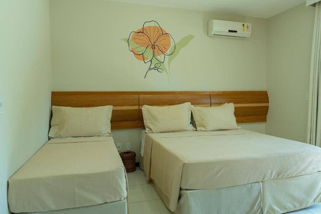 Postel nebo postele na pokoji v ubytování Orquídeas Praia Hotel