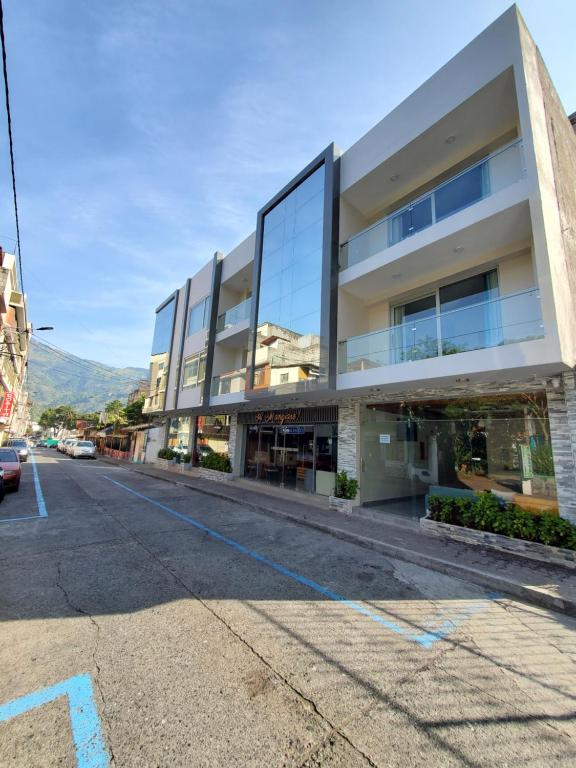 an empty street in front of a building at Xperience Hotel Ec in Baños