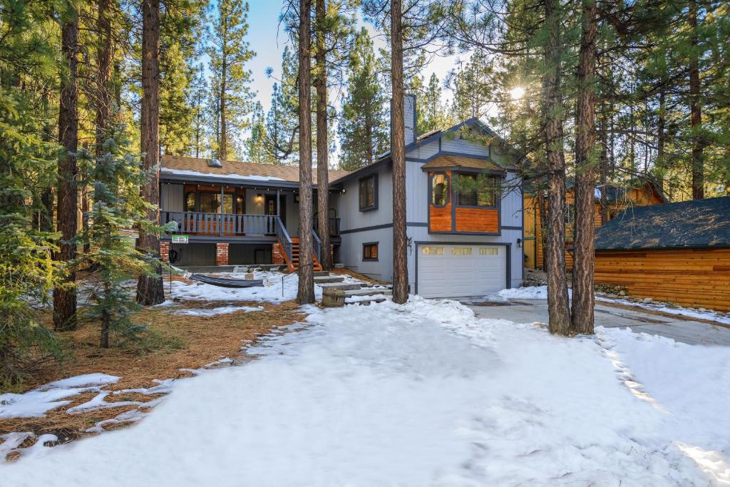 a house in the woods with snow on the ground at Serenity Summit Cabin in Big Bear Lake