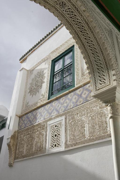 an archway with a window on a building at Palais Bayram in Tunis