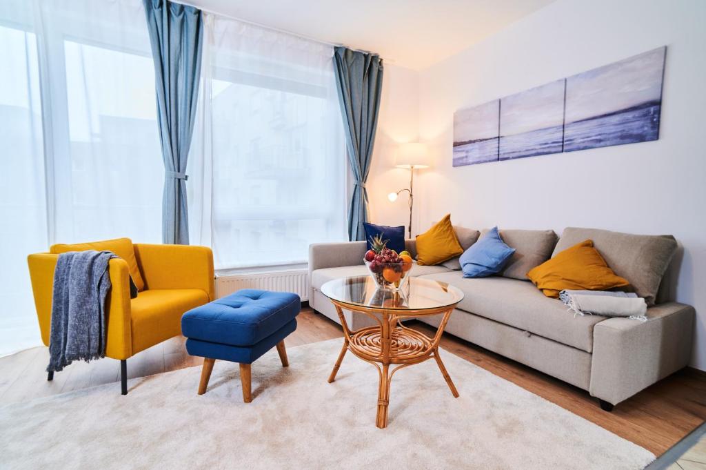 a living room with a couch and a table at FEEL HOME DeLuxe CORVIN -FREE PARKING-AC-Elevator in Budapest