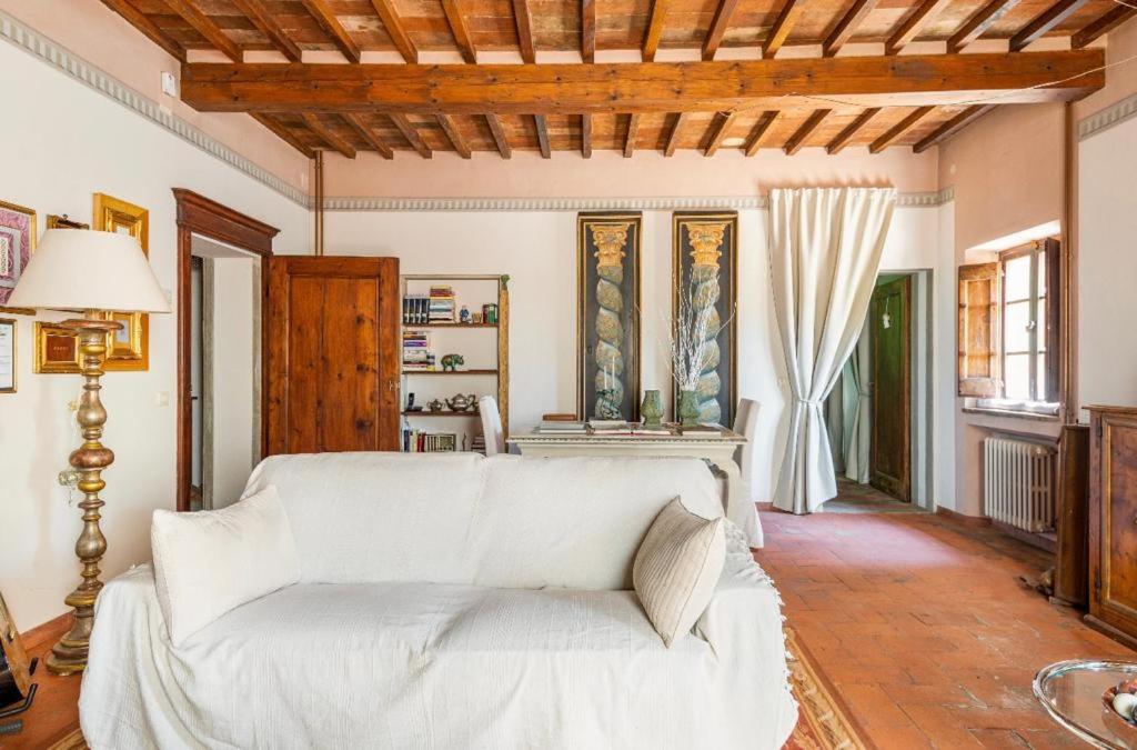 a living room with a white couch and a table at Villa San Filippo in Arezzo