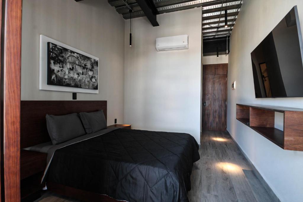 Giường trong phòng chung tại Hermoso y cómodo mini LOFT 5