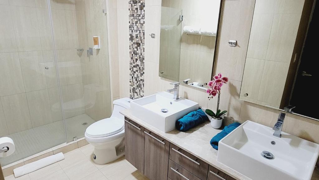 a bathroom with a sink and a toilet and a mirror at Exclusivo, Moderno y Cómodo Apto temático con hermosa Vista al Mar in Playa Blanca