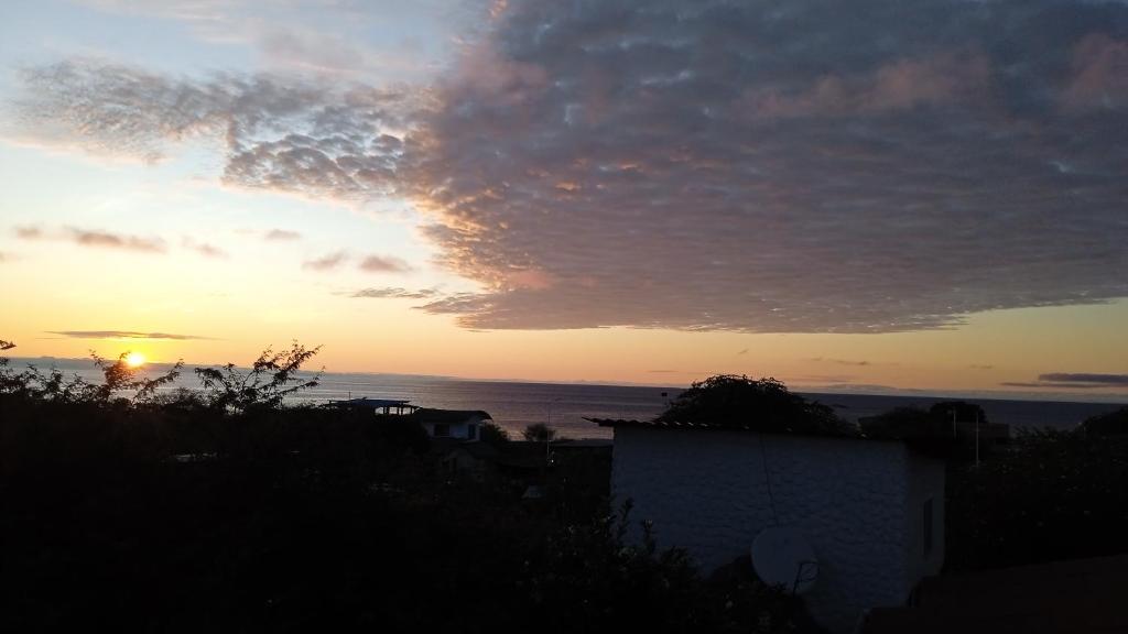 a sunset with the ocean in the background at El Pajas in Puerto Velasco Ibarra