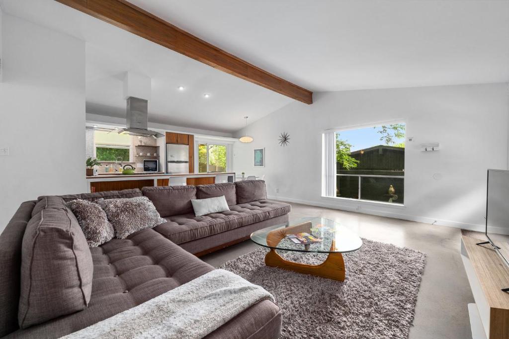a living room with a couch and a table at Quiet Haven with Huge Fenced Yard Fast Internet by Lodgewell in Austin