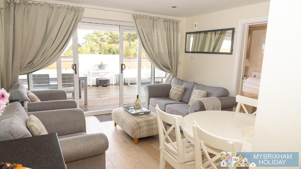 a living room with a couch and a table at Curlew 5 - The Cove in Brixham