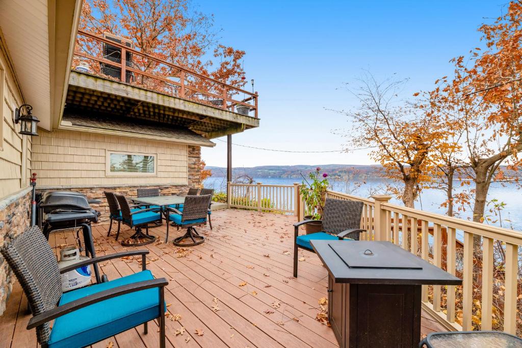 a deck with chairs and a table and a balcony at Live Laugh Lake - A in Rushville