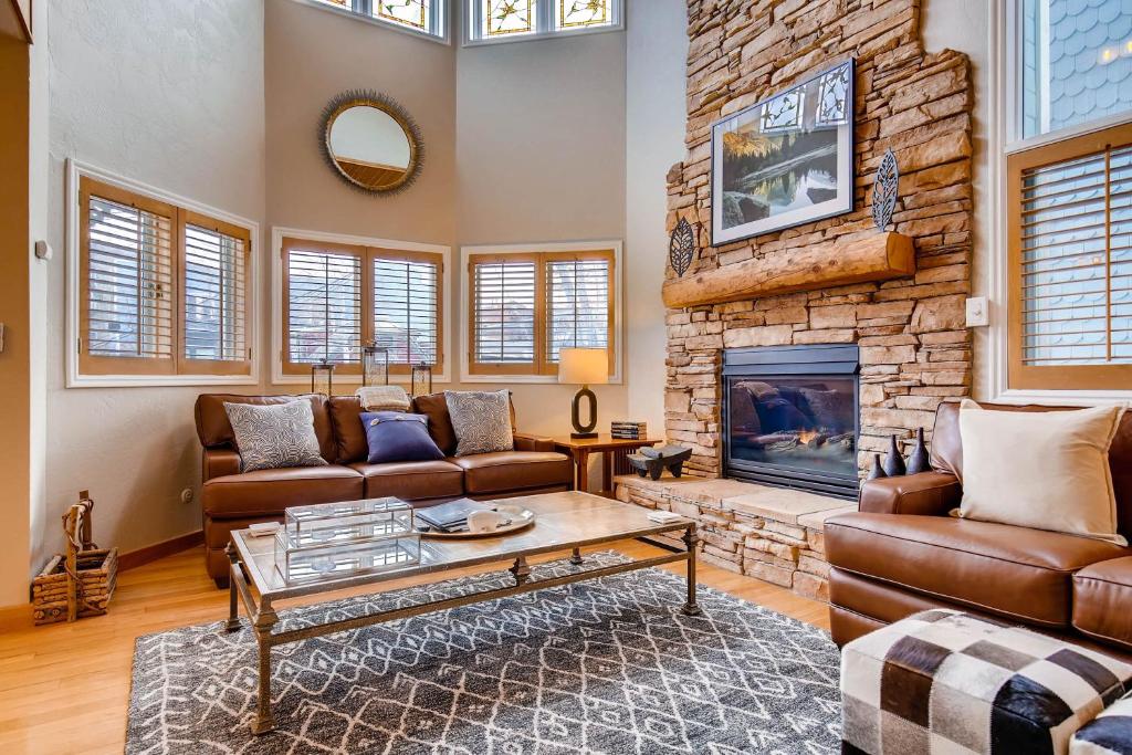 a living room with a couch and a fireplace at MOTHERLODE 3 townhouse in Park City
