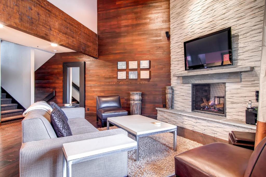 a living room with a couch and a fireplace at LAKESIDE 1629 townhouse in Park City