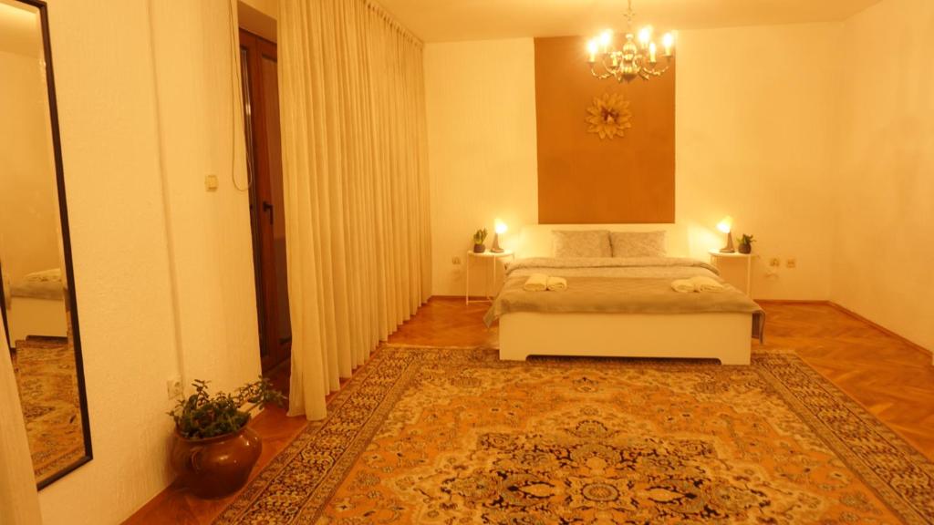 a bedroom with a bed and a large rug at Green land house in Belgrade