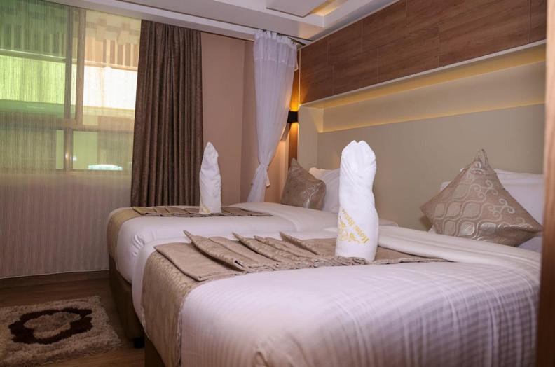 Postel nebo postele na pokoji v ubytování Hylise Hotel