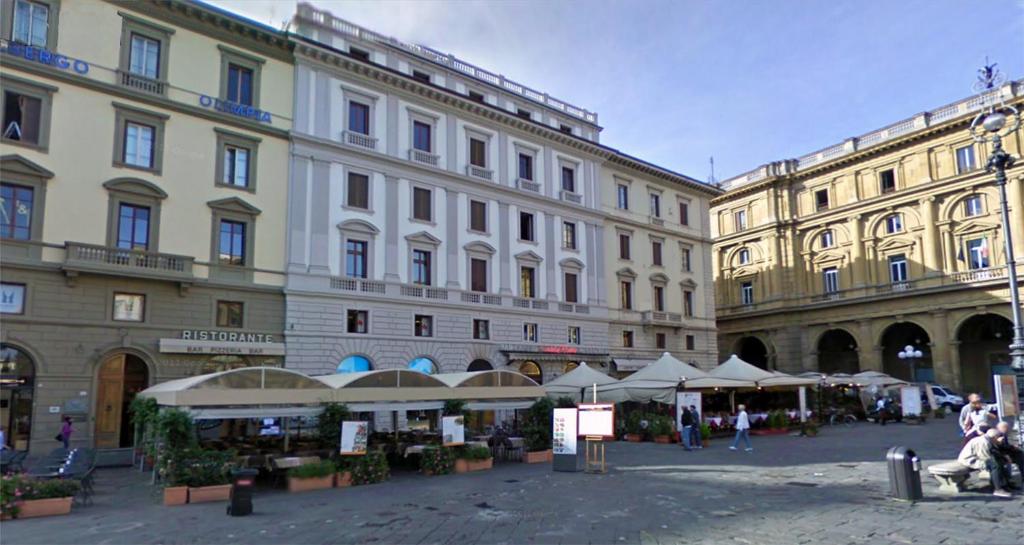 a group of buildings with umbrellas in a courtyard at B&B Dante Alighieri in Florence