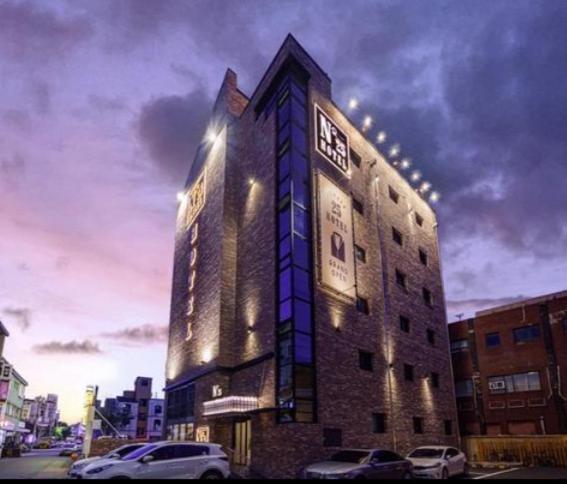 a building with a clock on the side of it at Number25 Hotel Namchuncheon in Chuncheon