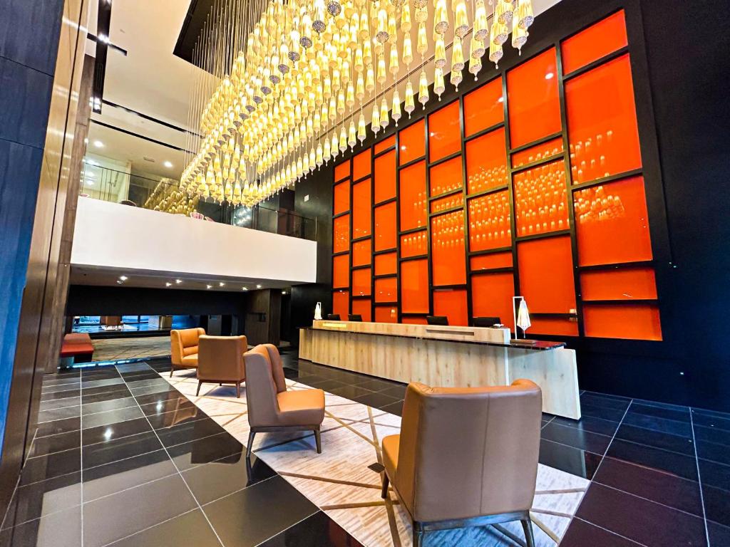 a lobby with chairs and a bar in a building at Stay with Bintang in Kuala Lumpur