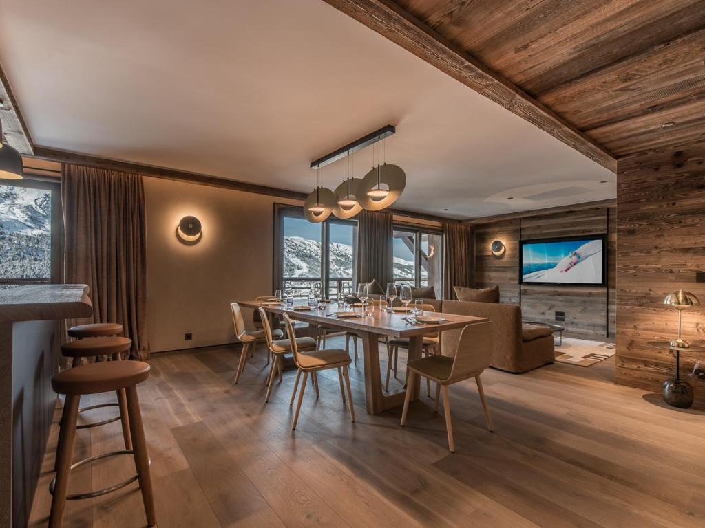 une salle à manger avec une table et des chaises dans l'établissement Superbe appartement skis aux pieds avec conciergerie 5*, Méribel - FR-1-613-64, à Les Allues