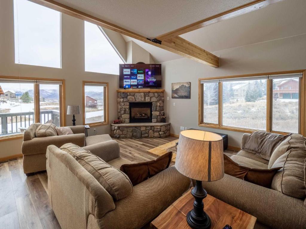 a living room with two couches and a fireplace at Overlook in Granby