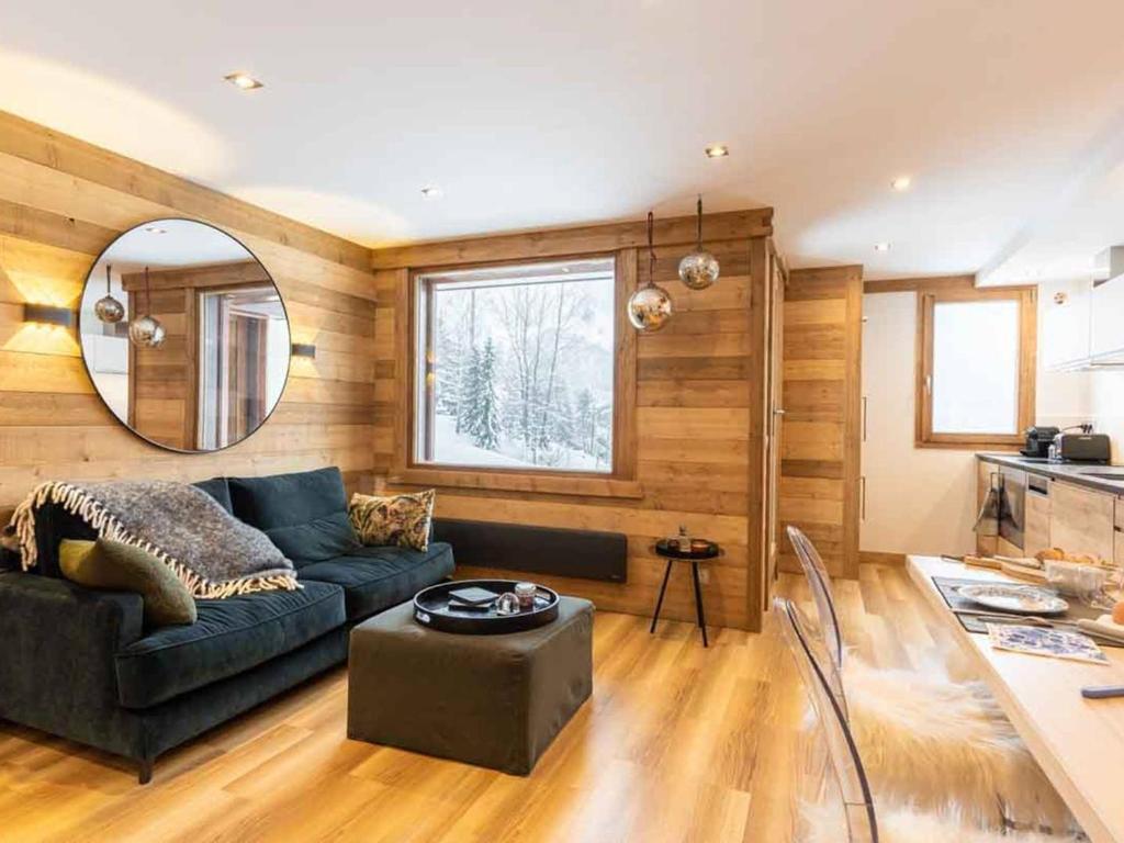 a living room with a couch and a table at Appartement Valmorel, 2 pièces, 3 personnes - FR-1-291-888 in Valmorel