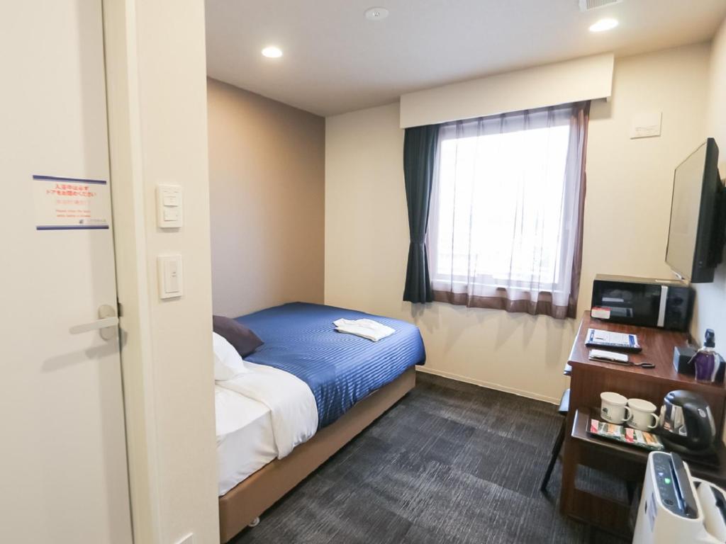 Camera piccola con letto e finestra di HOTEL LiVEMAX Aichi Toyota Ekimae a Toyota
