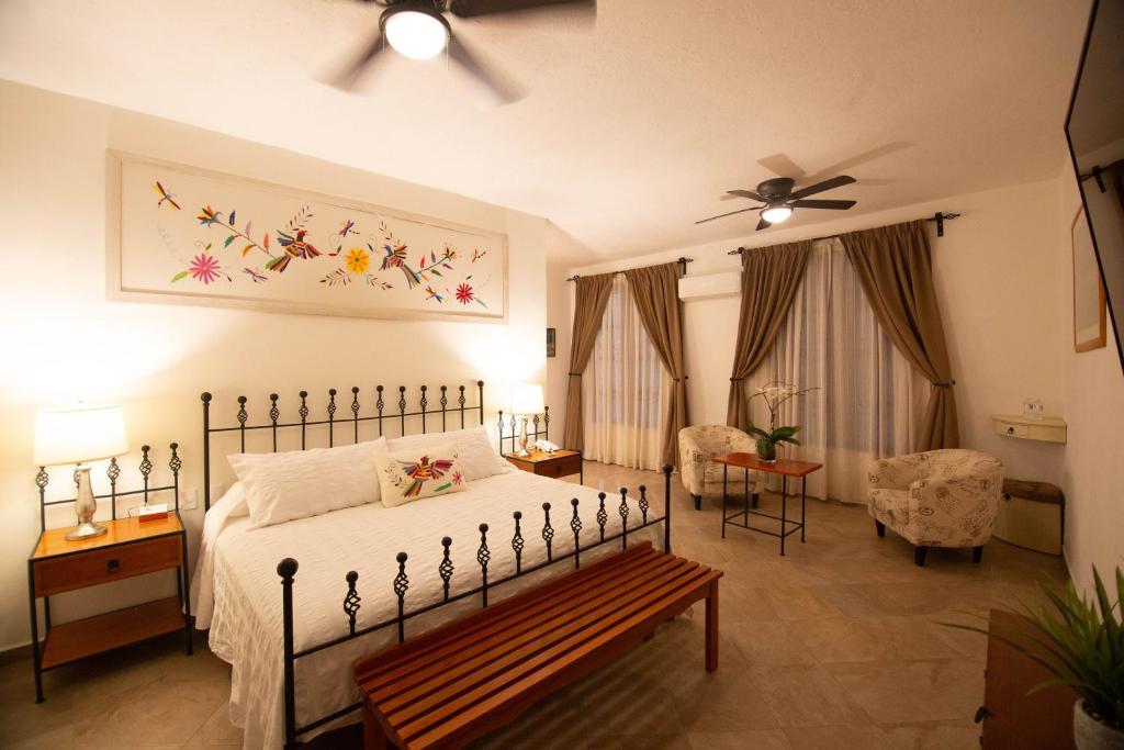 a bedroom with a bed and a couch at Ex Hacienda Santa Cecilia in Cuernavaca