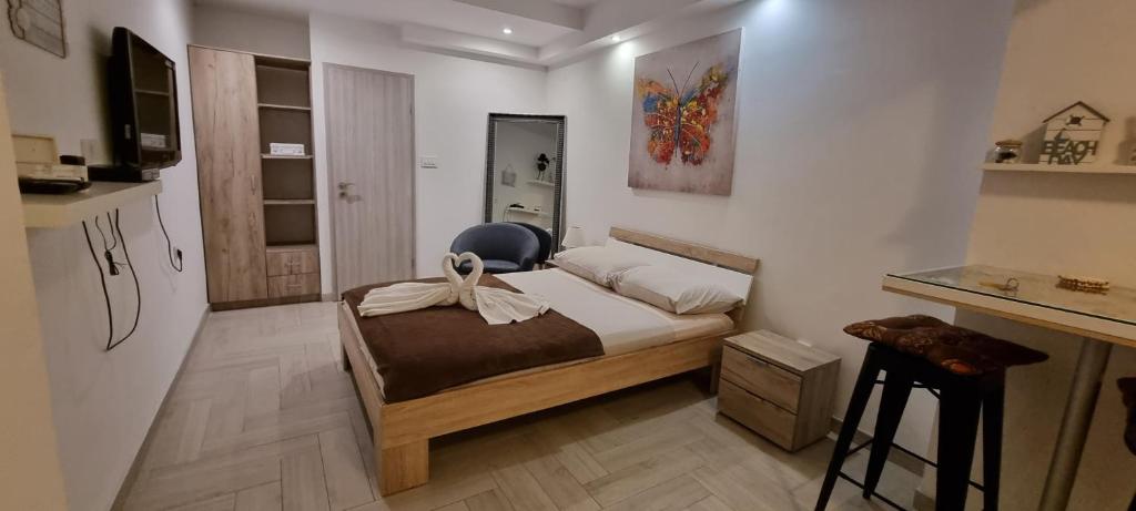 a bedroom with a bed with a bow on it at Apartmani Tatić Štinjan in Štinjan
