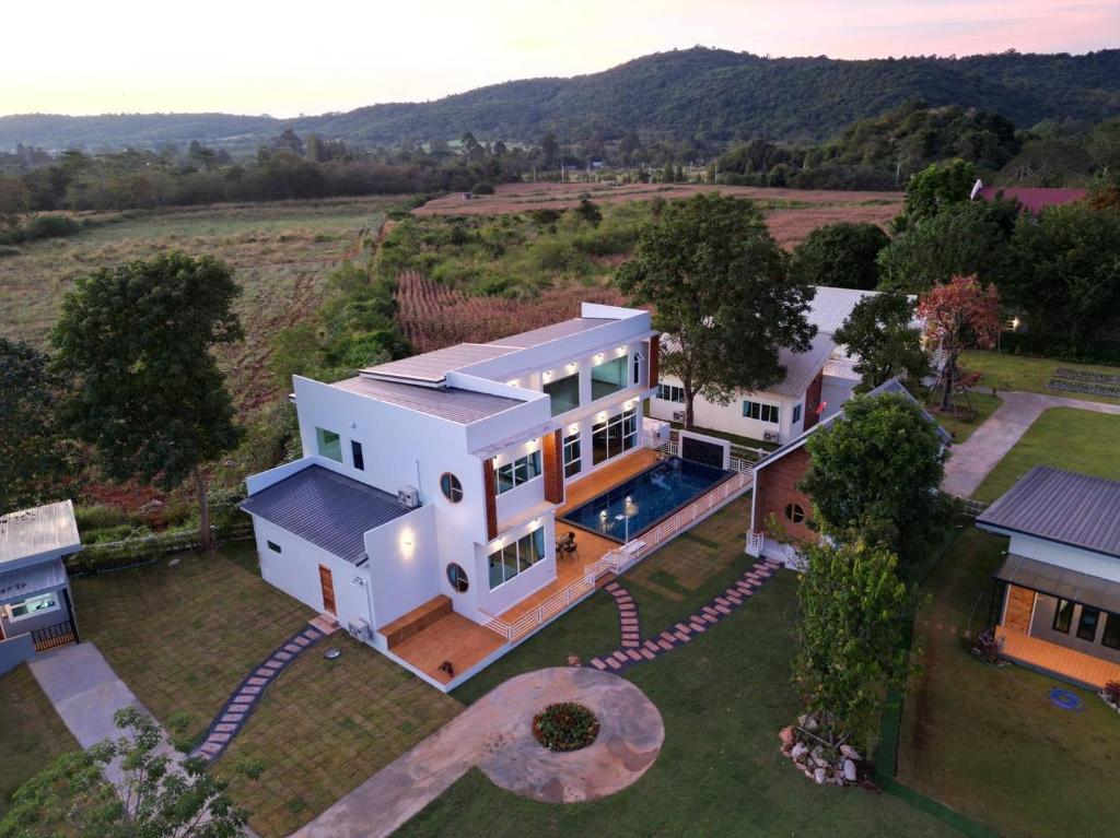 an aerial view of a house with a swimming pool at ถึงเที่ยงวัลเลย์เขาใหญ่ in Ban Bung Toei