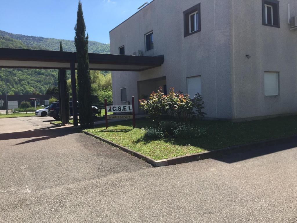 a building with a sign in front of it at Chambre atypique in Domène