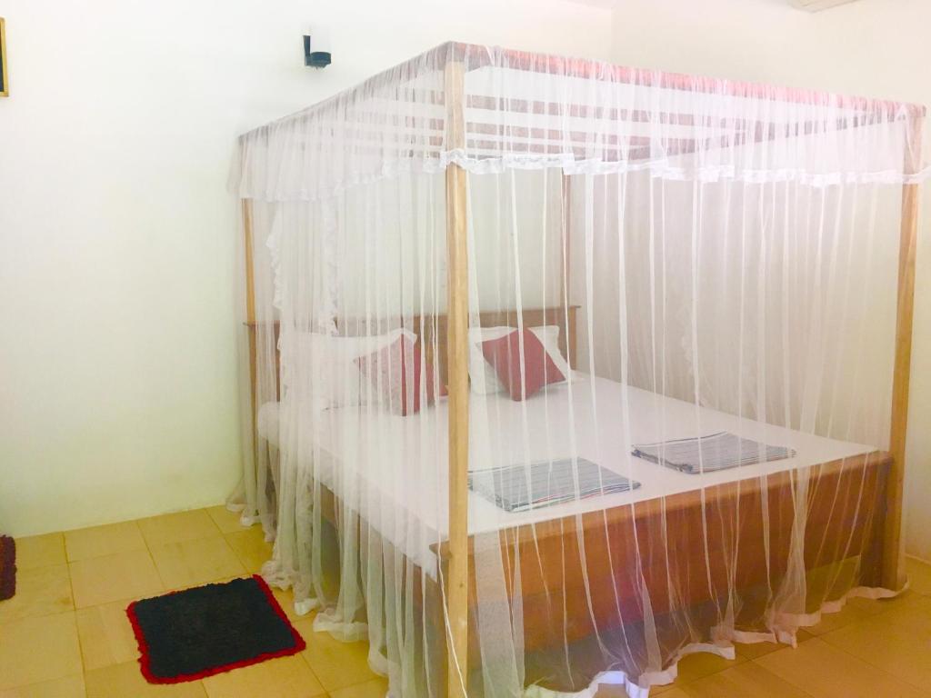 Postel nebo postele na pokoji v ubytování Arachchi Guest House
