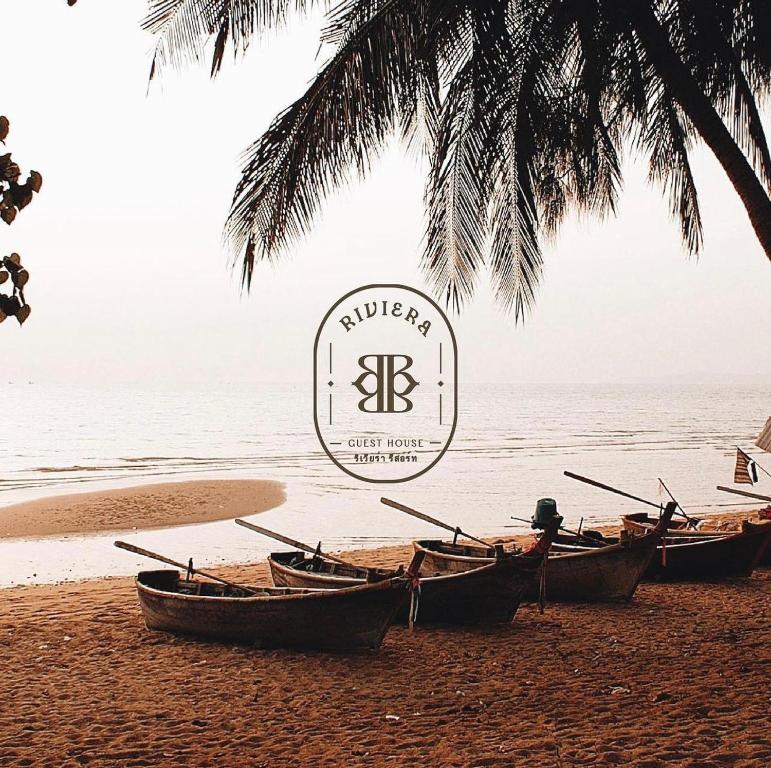 a group of boats sitting on the beach at Riviera Patong in Patong Beach