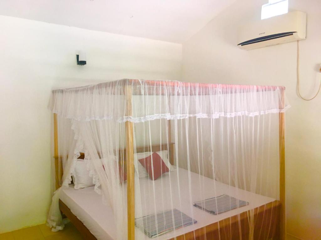 Postel nebo postele na pokoji v ubytování Arachchi Guest House