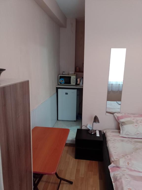 A bed or beds in a room at Top Center Apartment and Rooms Varna