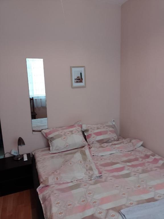 A bed or beds in a room at Top Center Apartment and Rooms Varna