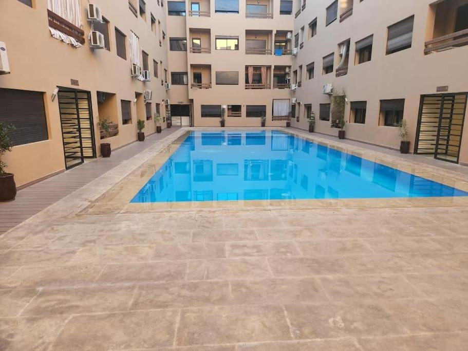 a swimming pool in the middle of a building at Appartement de rêve 2 in Marrakech