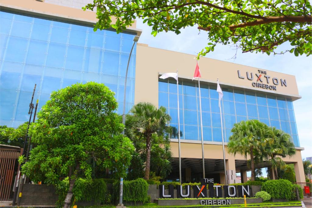 a building with a sign in front of it at The Luxton Cirebon Hotel and Convention in Cirebon
