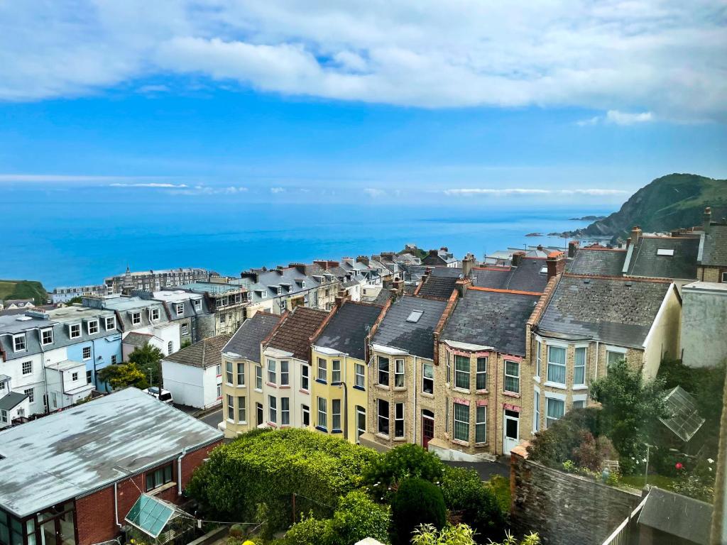 a city with houses and the ocean in the background at The Lookout in Ilfracombe
