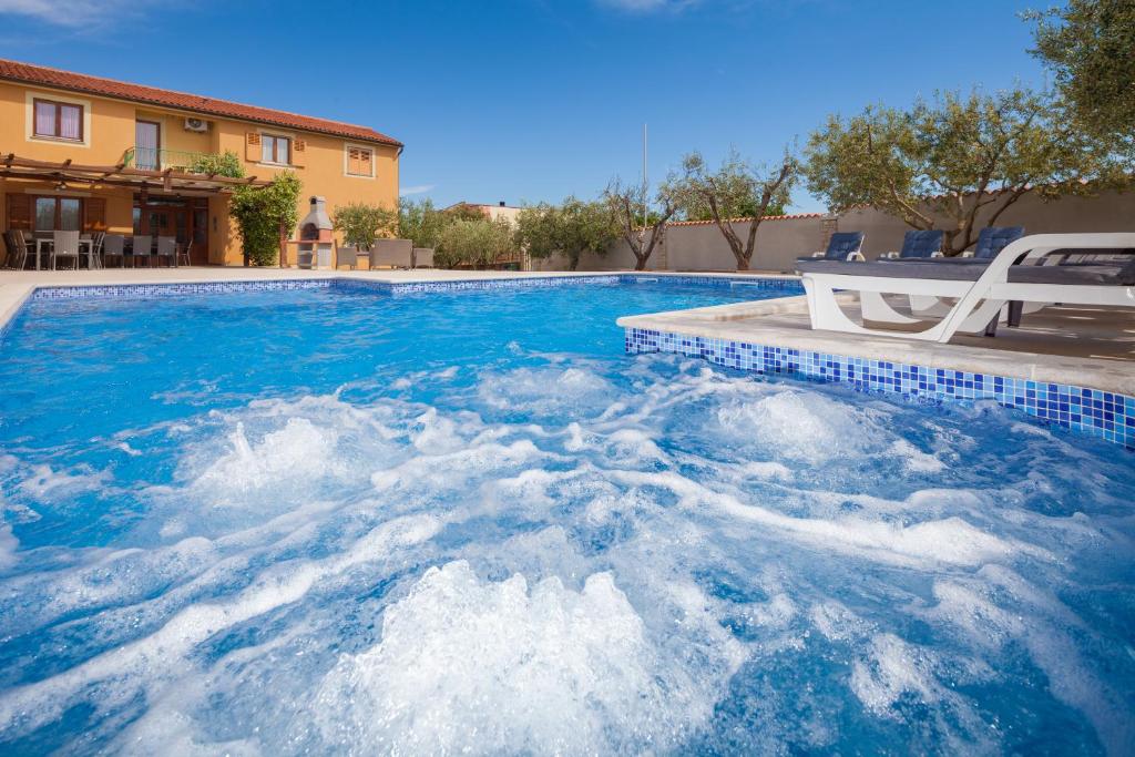 a swimming pool with blue water in a house at Villa Mirjana in Banjole