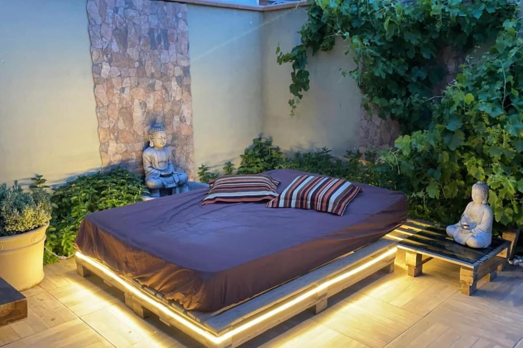 a bedroom with a large bed in a garden at Casa chill in San Martín de la Vega