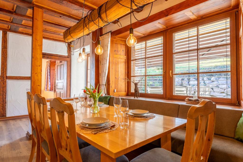 a dining room with a wooden table and chairs at Ferienwohnung Alex in Ühlingen-Birkendorf