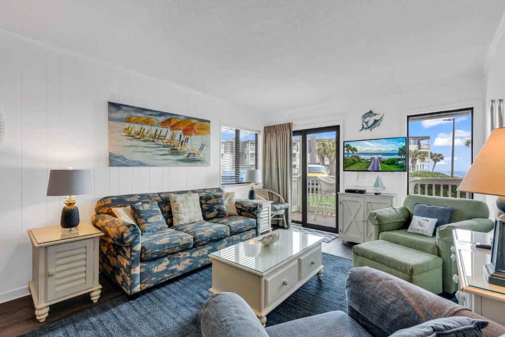 a living room with a couch and a table at 2 BR Ocean Forest Villa Steps Away From Pristine Sandy Beaches in Myrtle Beach