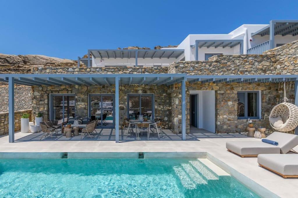 a villa with a swimming pool and a house at Roca Bonita villa in Elia Beach