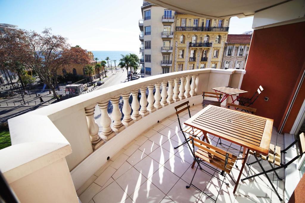 a balcony with a table and chairs on a building at Domes Seaside Résidence Piscine, Free Parking, Airport Tramway in Nice