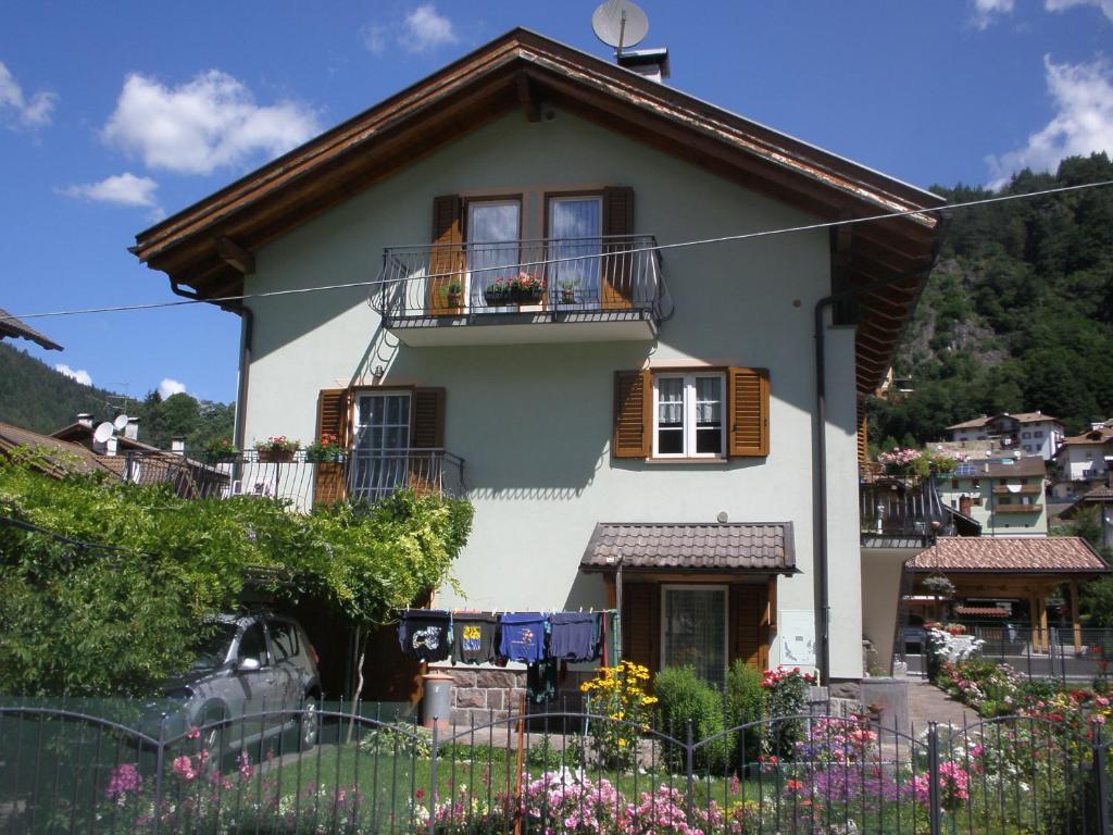 a white house with windows and a balcony at Aprt Val di Fiemme - Molina in Castello di Fiemme