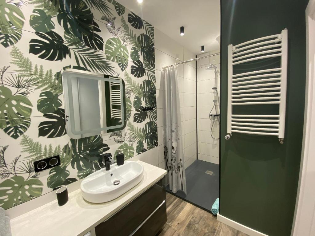 a bathroom with a sink and a shower at Apartament FOCUS DUO in Gdańsk