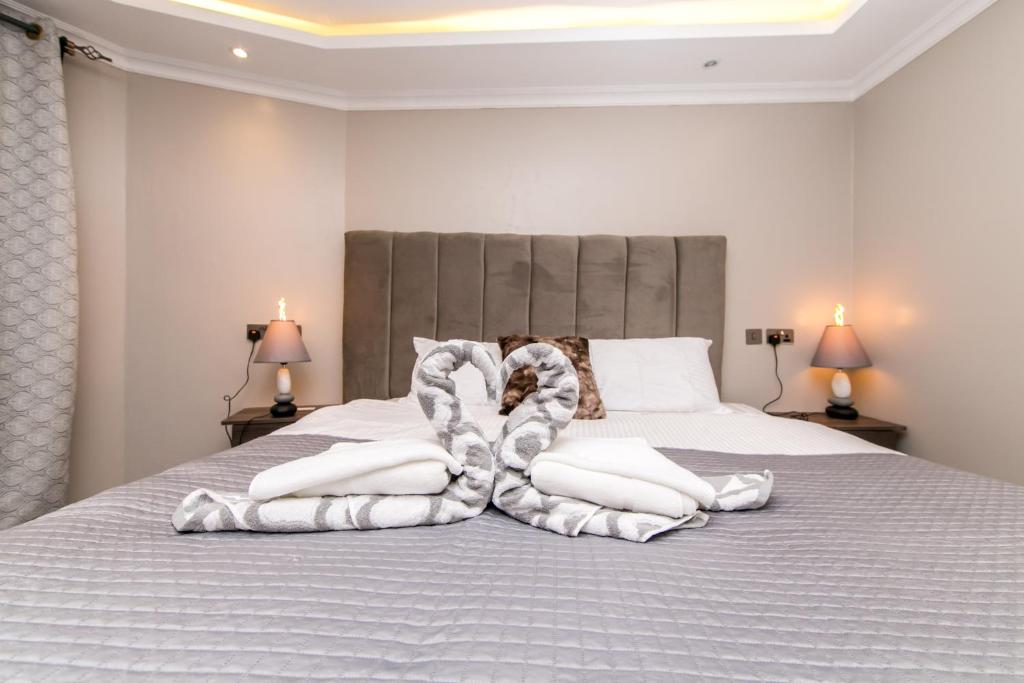 a bedroom with a bed with white sheets and blankets at 41 Haven in Nairobi