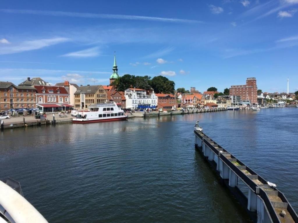 a view of a river with boats and buildings at FerienanlageKappeln in Kappeln