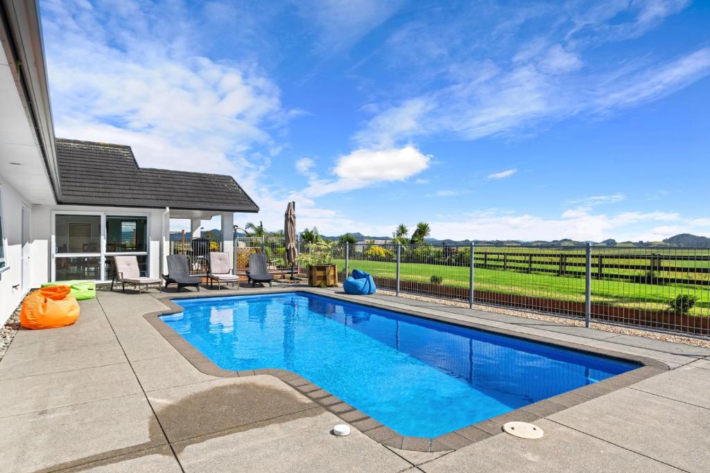 a swimming pool in the backyard of a home at Green View - Parua Bay Holiday Home in Parua Bay