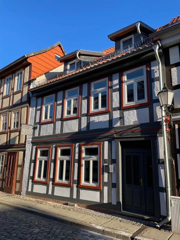a black and white building with windows on a street at Ferienhaus Harzcolor Wernigerode in Wernigerode