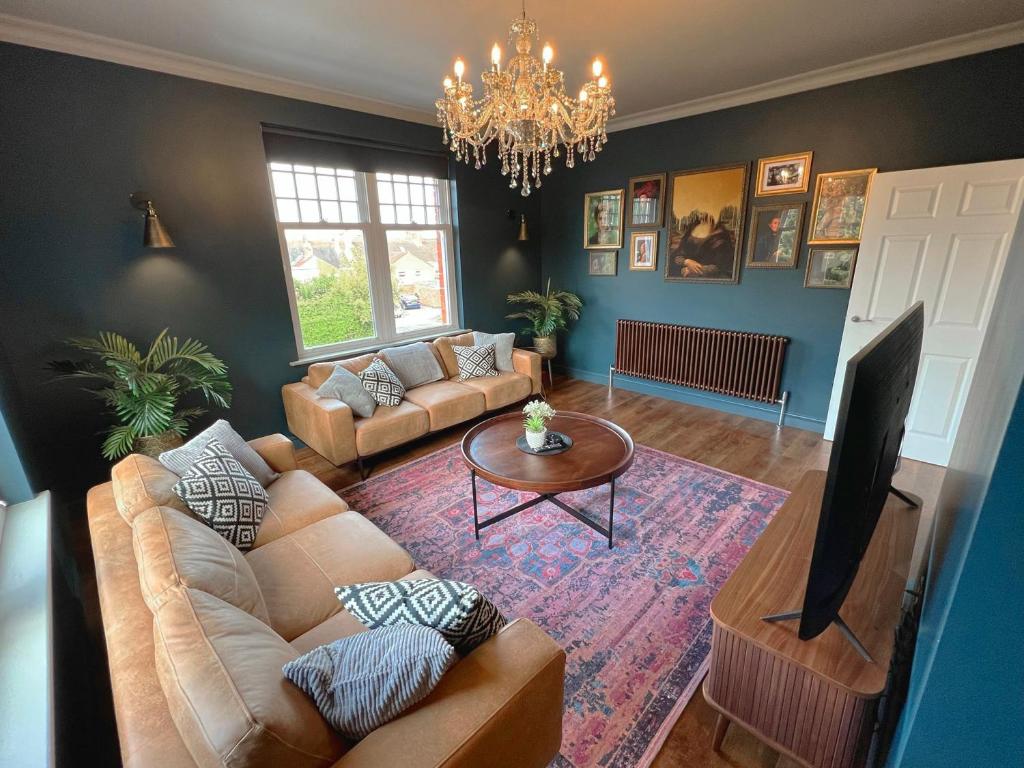 ein Wohnzimmer mit einem Sofa und einem Tisch in der Unterkunft West Hendford House - Apt 1 in Yeovil