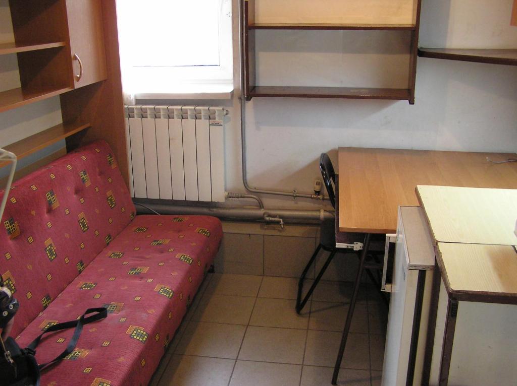 A-Netflix parking kawalerka mała Halczyna 9 doCentrum 6 przystanków في كراكوف: غرفة صغيرة مع أريكة حمراء في مطبخ